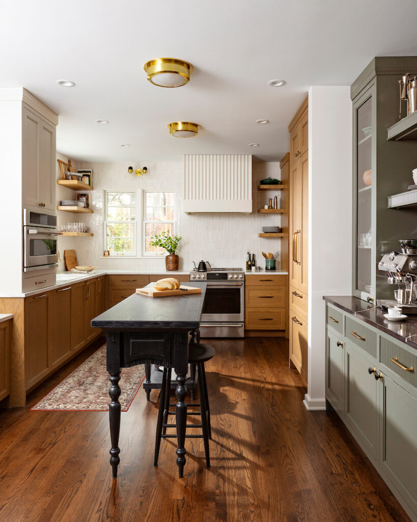 Kitchen remodel in a 1936 Whitefish Bay Tudor with a custom island inspired by an 1890s bank teller's table